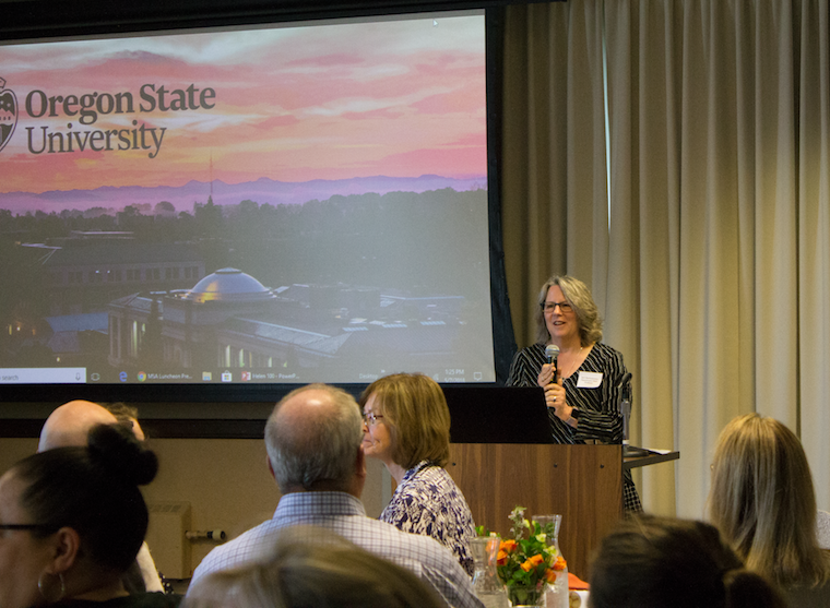 Jerri Bartholomew presenting to audience on podium