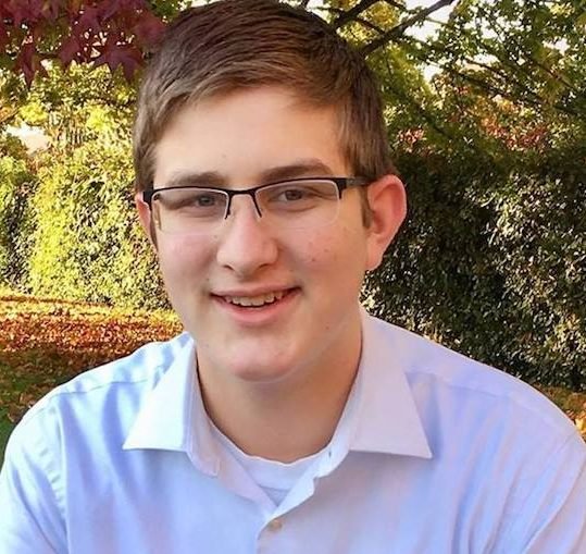Eli Nicholas sitting outside
