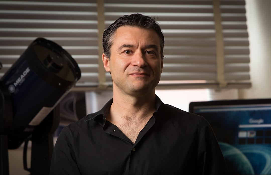 Davide Lazzati sitting in office space with equipment