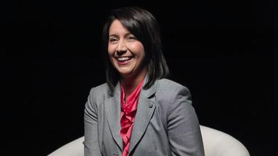 Ginger Kerrick sitting in front of black backdrop