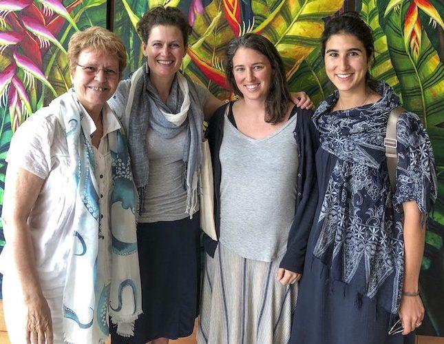 Jane Lubchenco, Kirsten Grorud-Colvert with Jenna Sullivan and Vanessa Constant standing in front of shrubbery