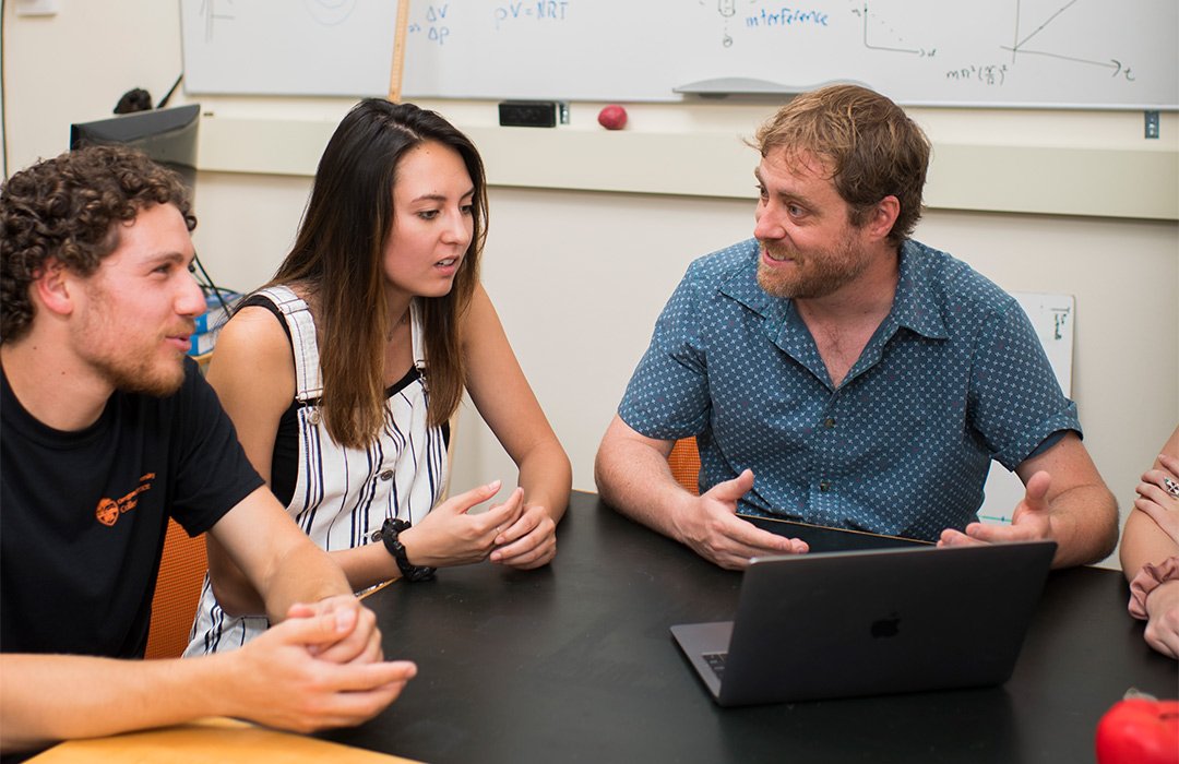 KC Walsh and students sitting in study room for tutor session