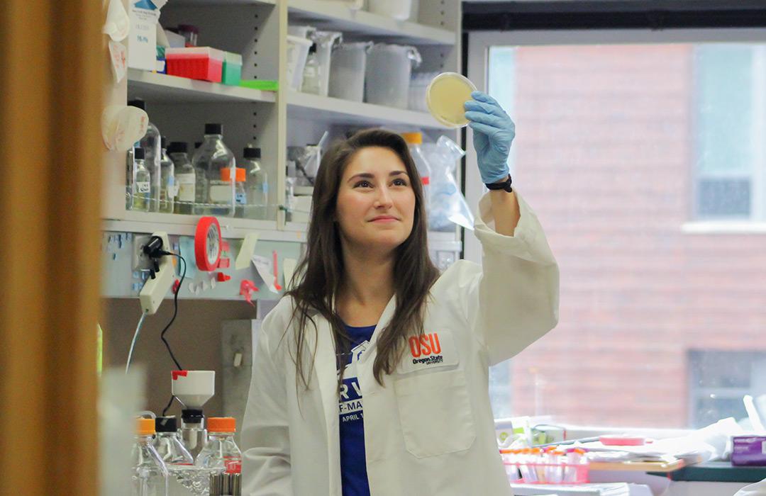 Kendra Jackson working with beaker in lab