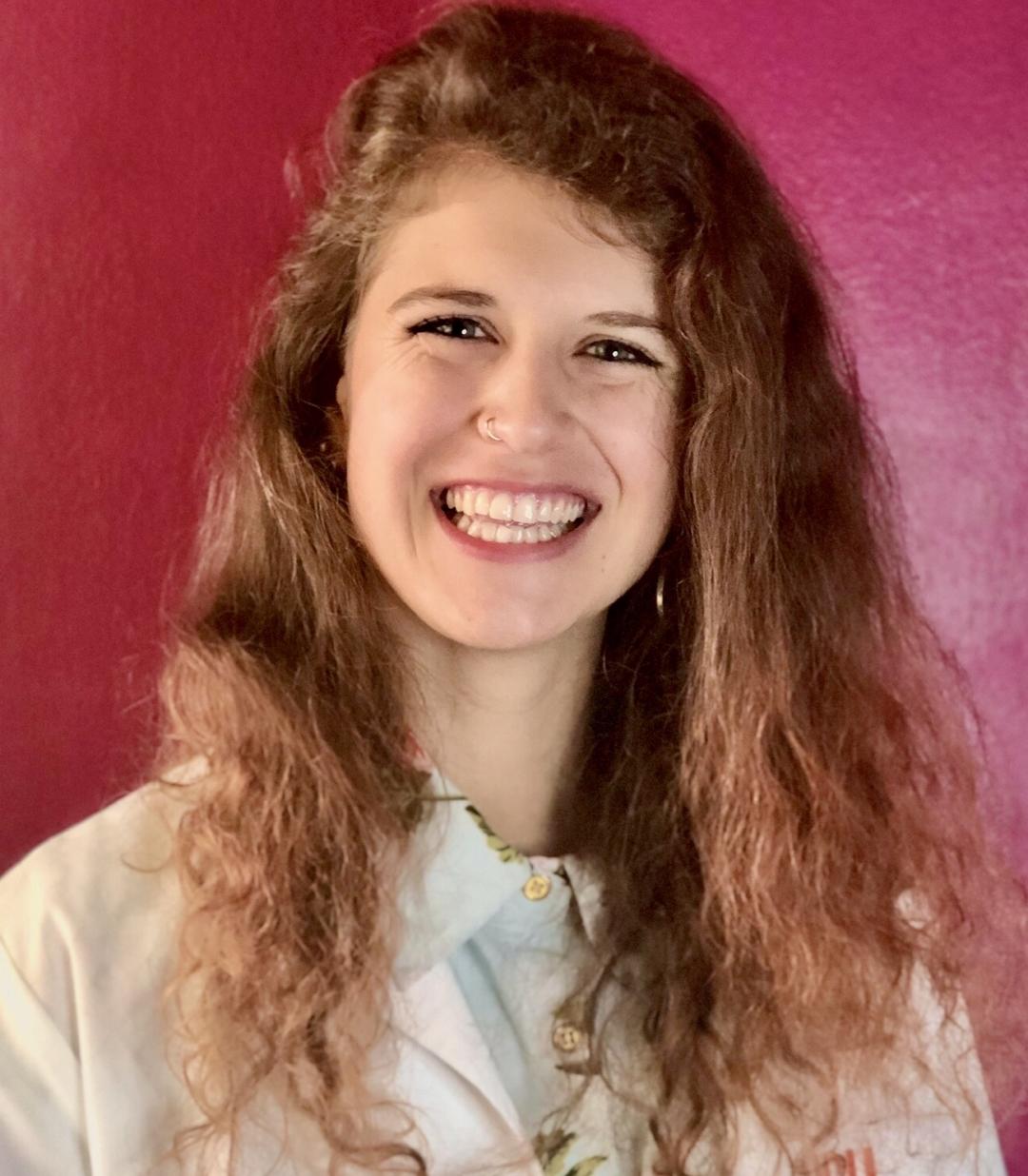 Heather Masson Forsythe in front of a red background