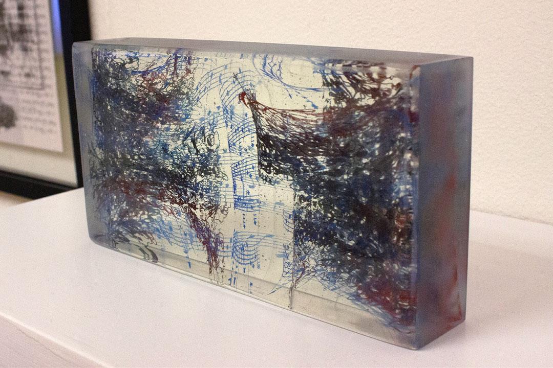 Artwork, a piece of glass with music inspired by the coronavirus spike protein flowing through it.