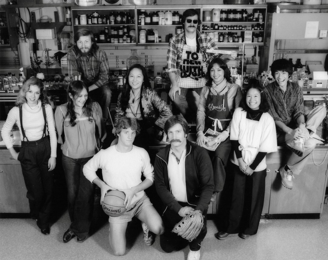 Leong's staff and graduate students posing with smiling faces and sports equipment.