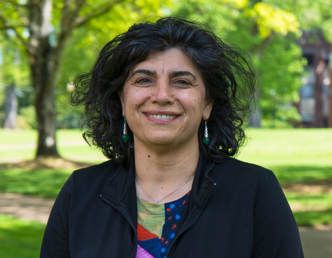 Smiling woman in a colorful shirt on OSU campus