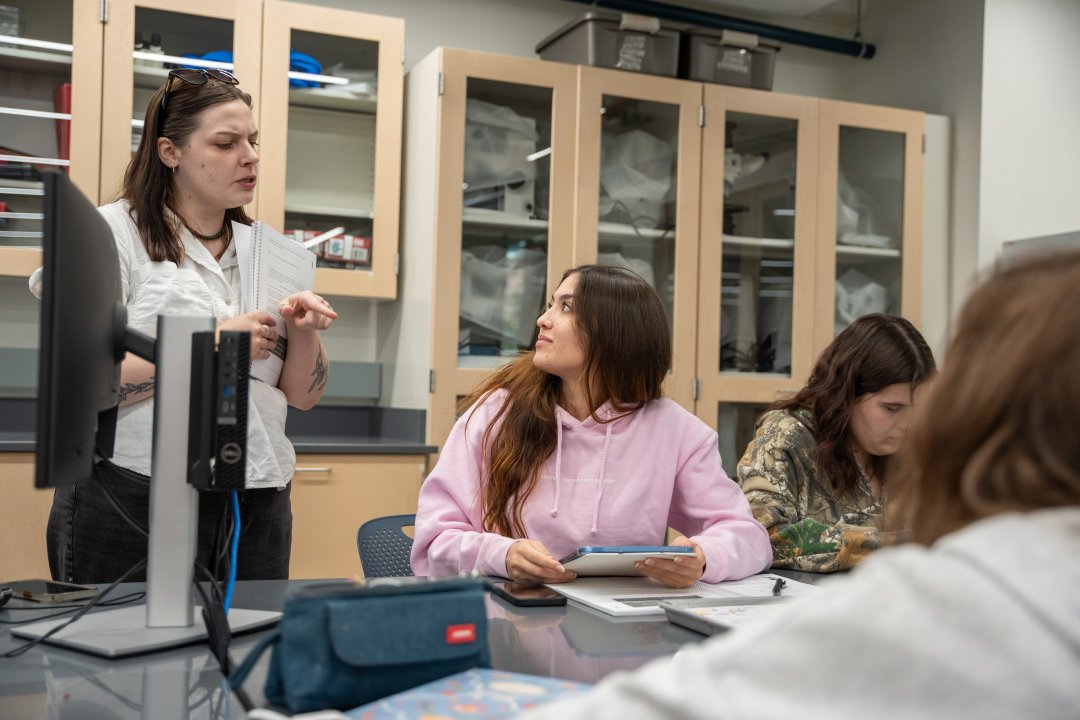 Students in a laboratory classroom working with notebooks.
