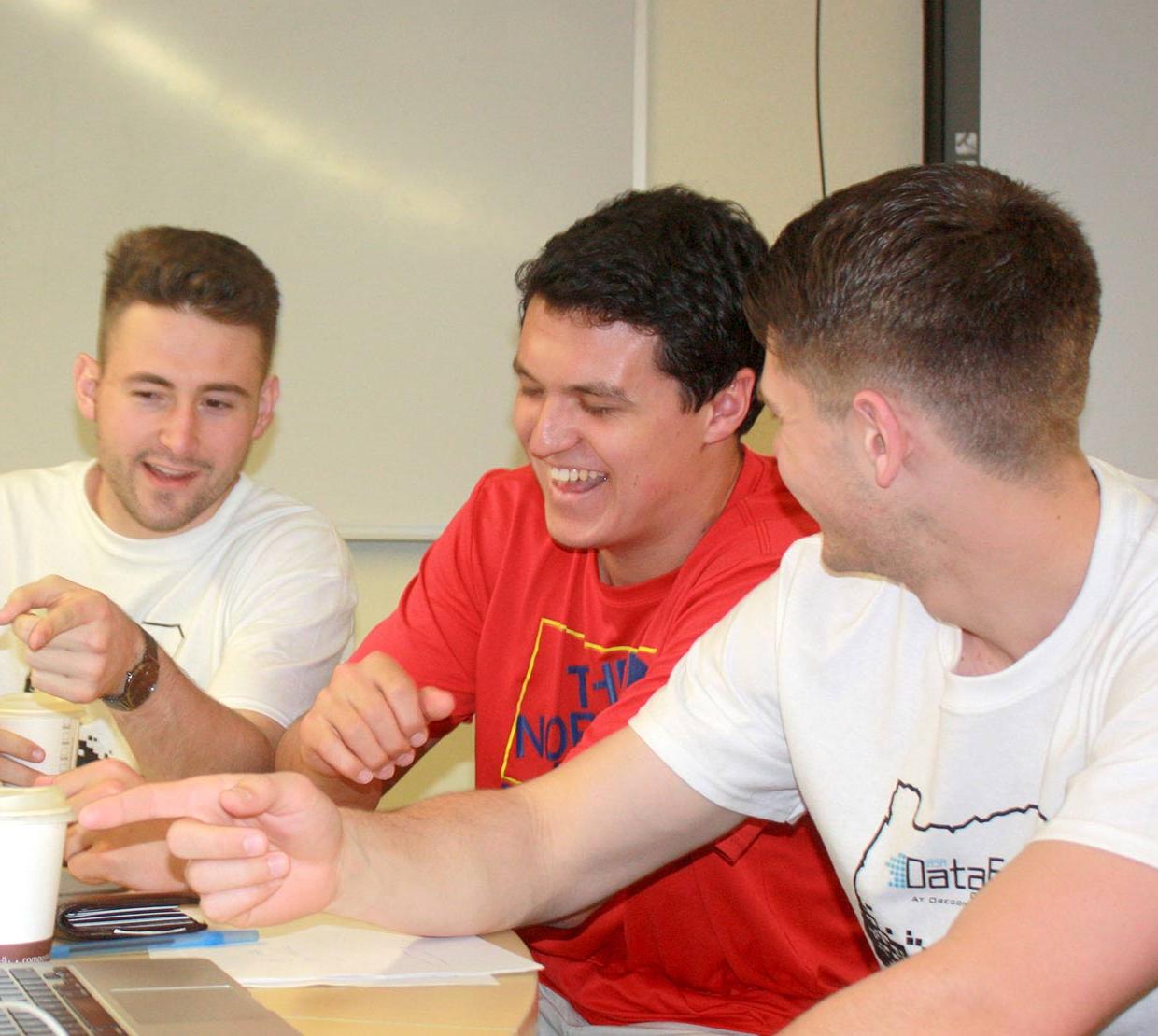 Male students interacting with data fest booth