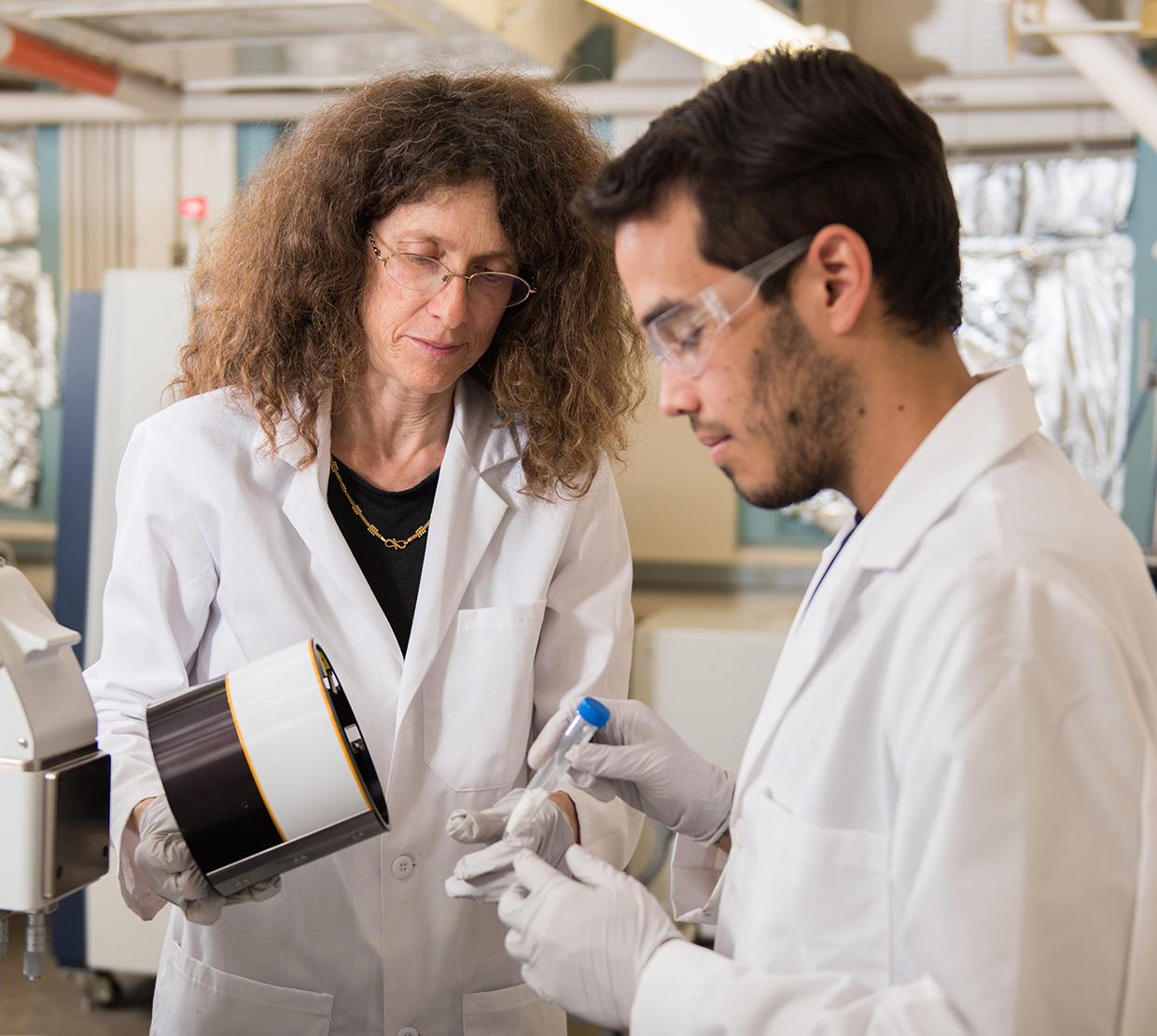May Nyman with student working in lab