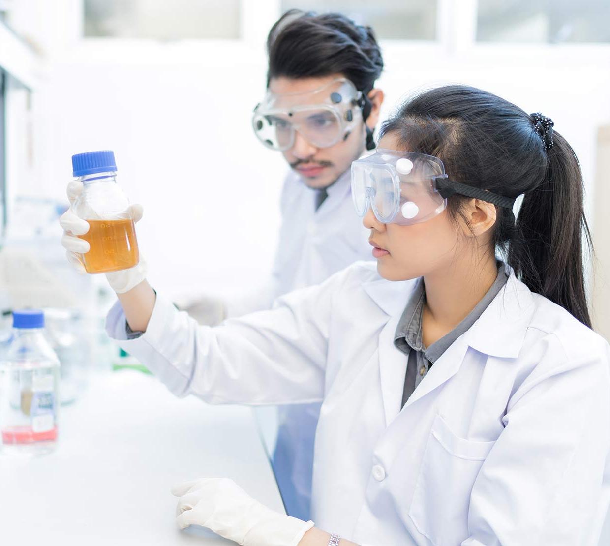 students analyzing beakers in lab