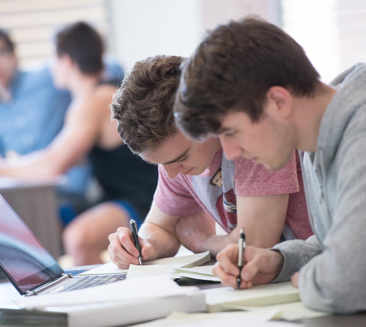 Two students studying together in classroom