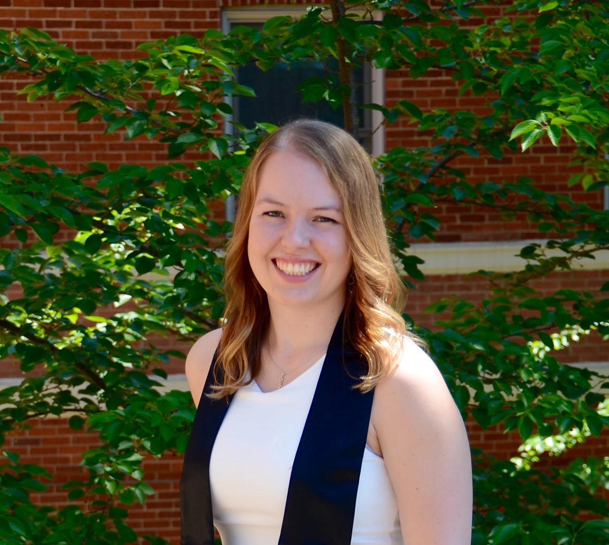Katherine Banowetz standing in front of shrubbery