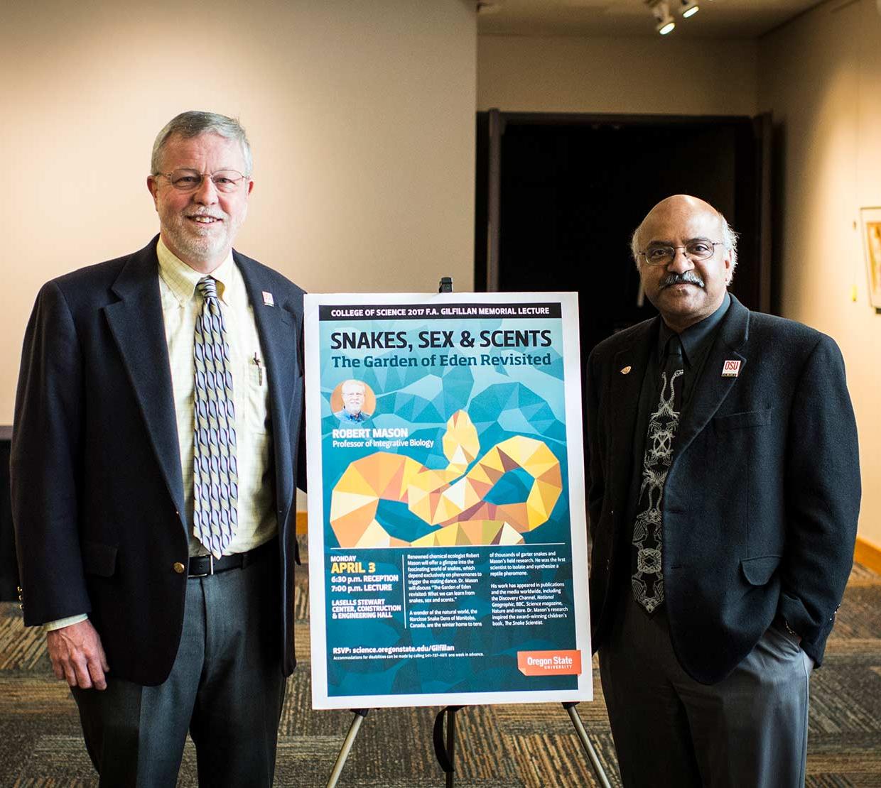 Robert Mason and Sastry Pantula standing next to event poster