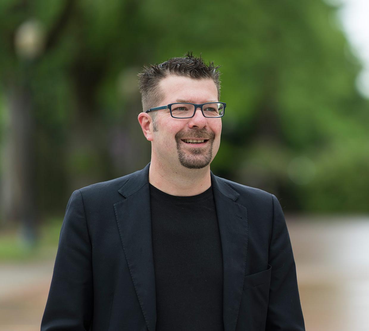 Xavier Siemens standing outside Memorial Union brick walkway