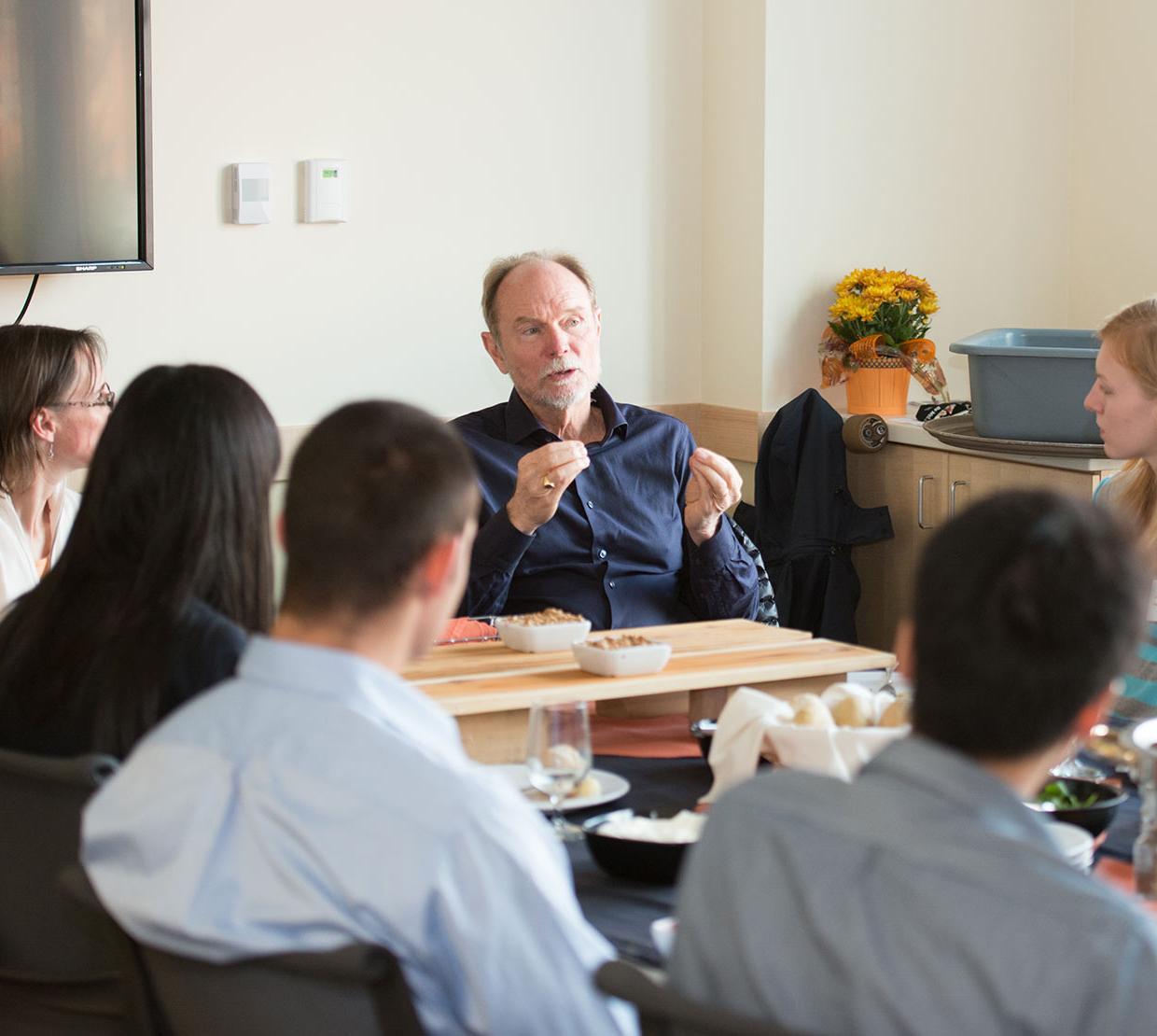 Joel Peterson talking to science staff in meeting
