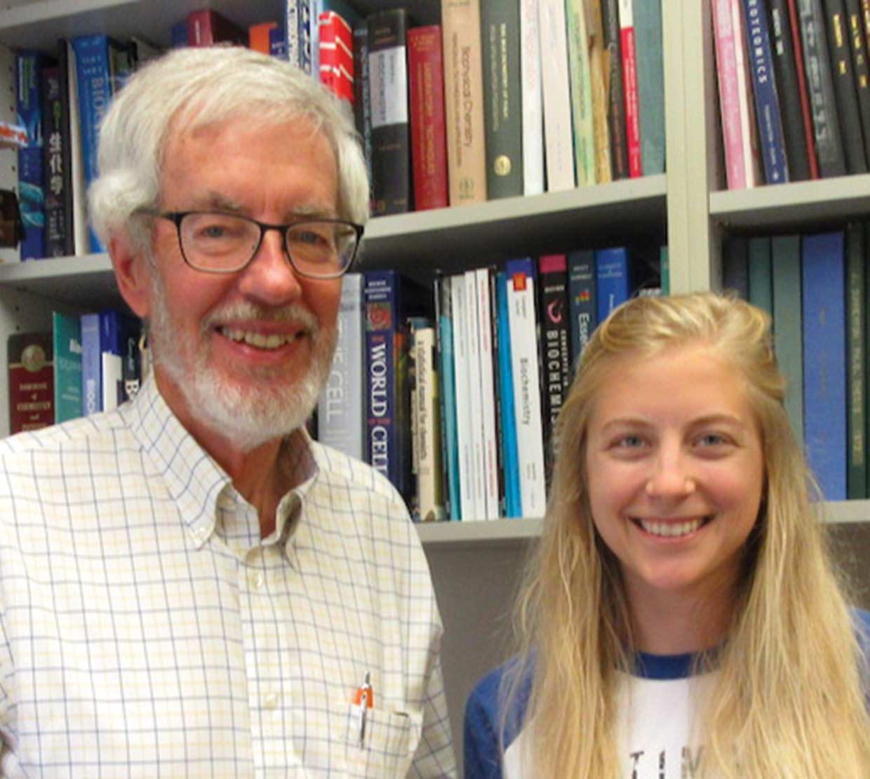 Michelle Wiley with Chris Mathews in front of book shelves