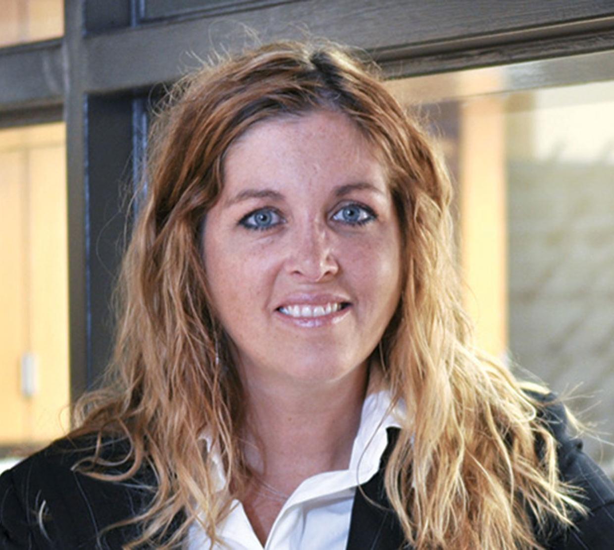 Karen Wooley standing in hallway in front of window
