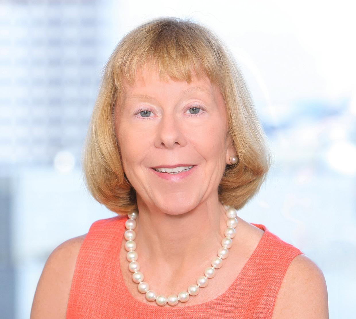 Suzanne McGrath standing in front of cityscape