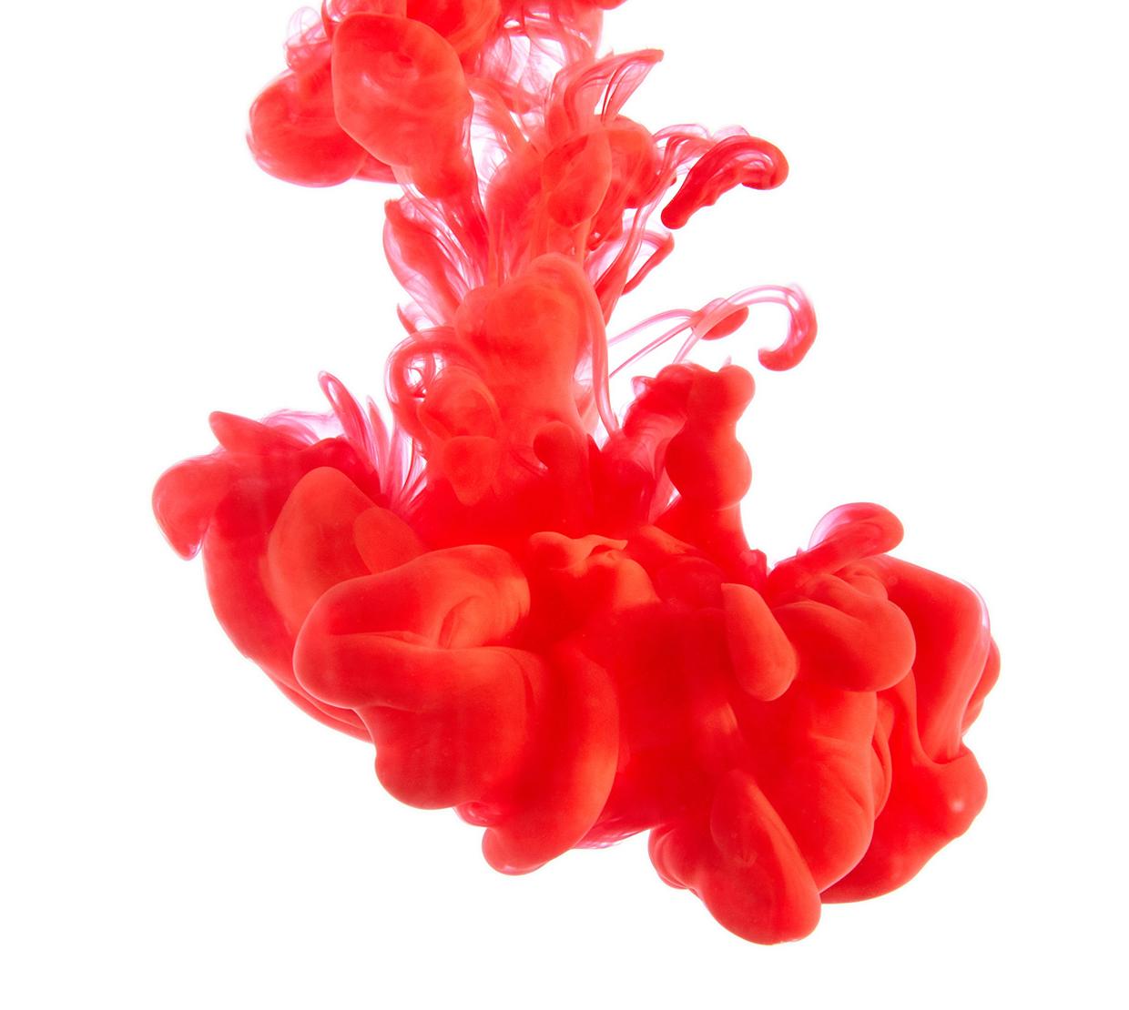 red pigment dropped into white liquid