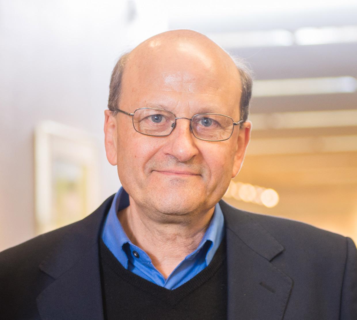 Enrique Thomann standing in office hallway