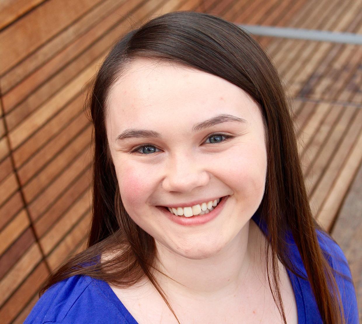 Christina Moody sitting on bench in SEC awning