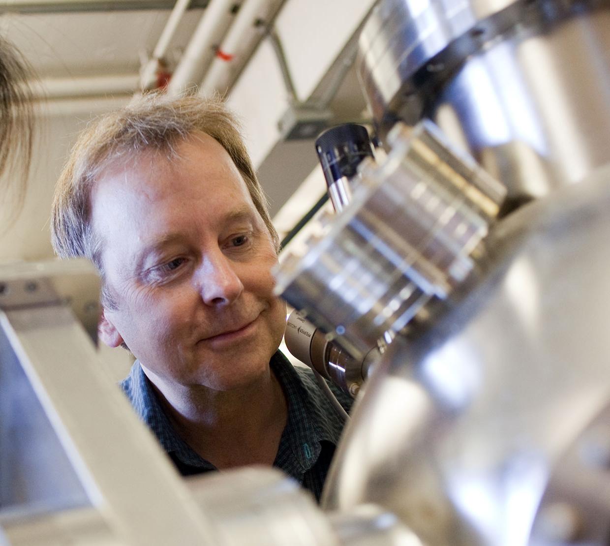 Doug Keszler looking though instruments in lab