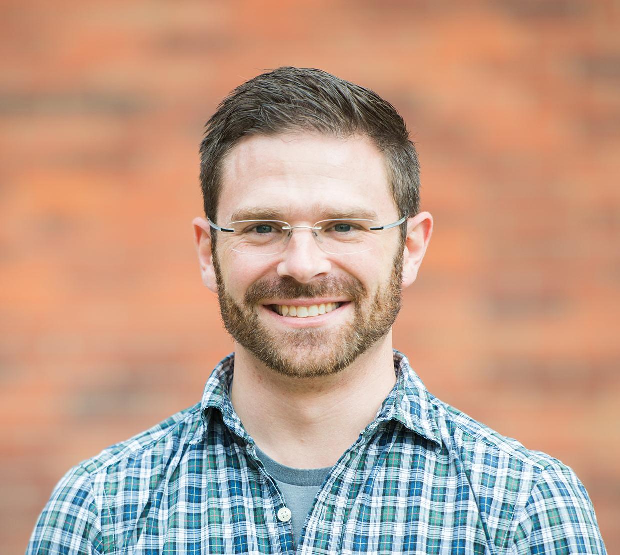 David Koslicki in front of brick wall