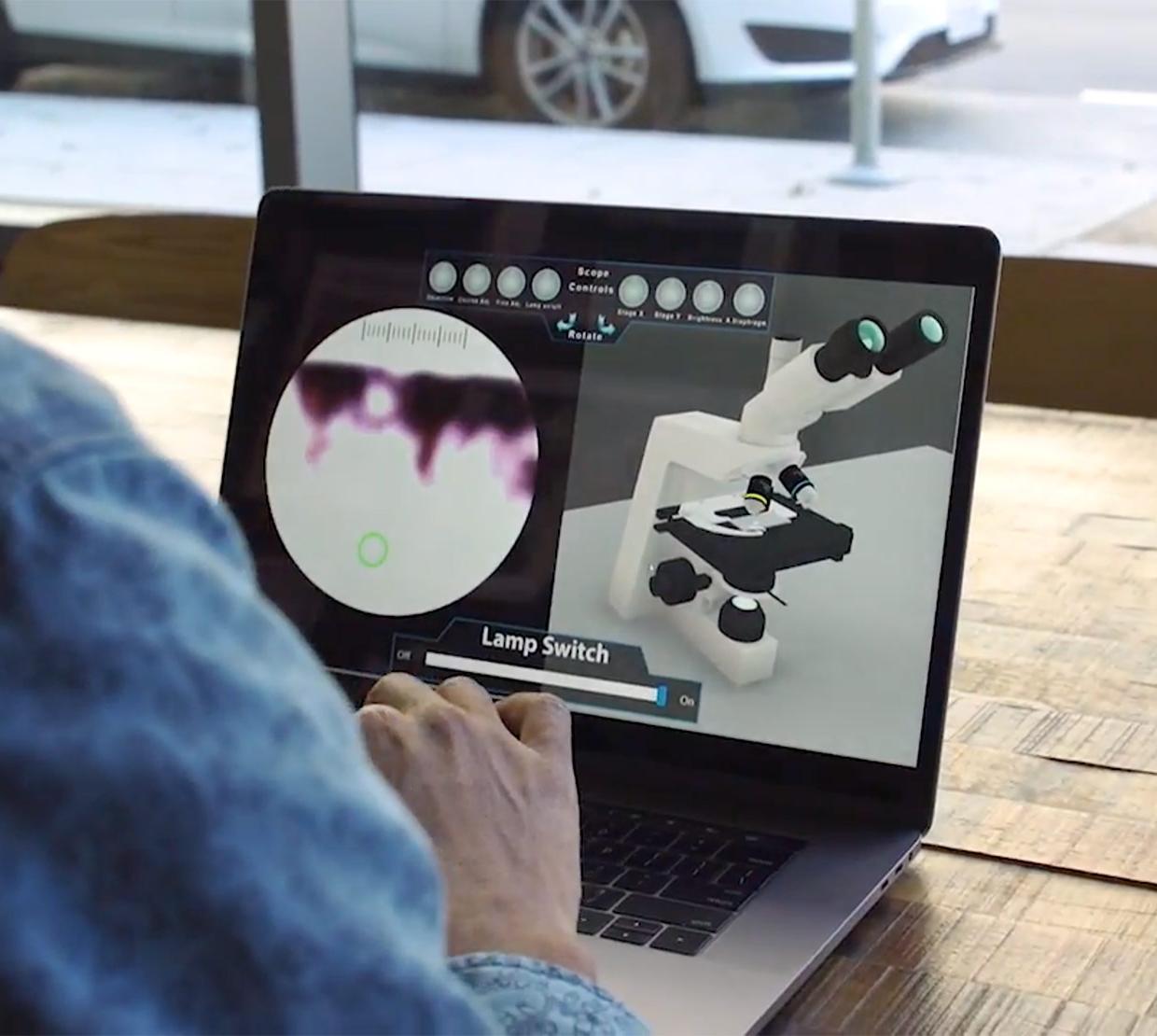 student using 3d virtual microscope o their laptop in coffee shop