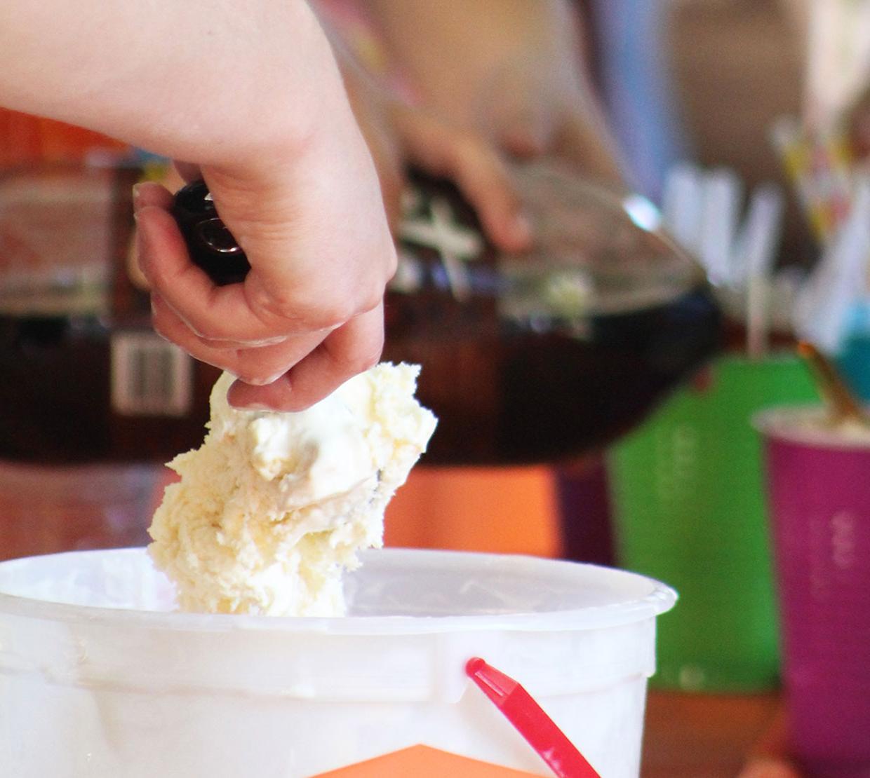 Hand scooping ice cream