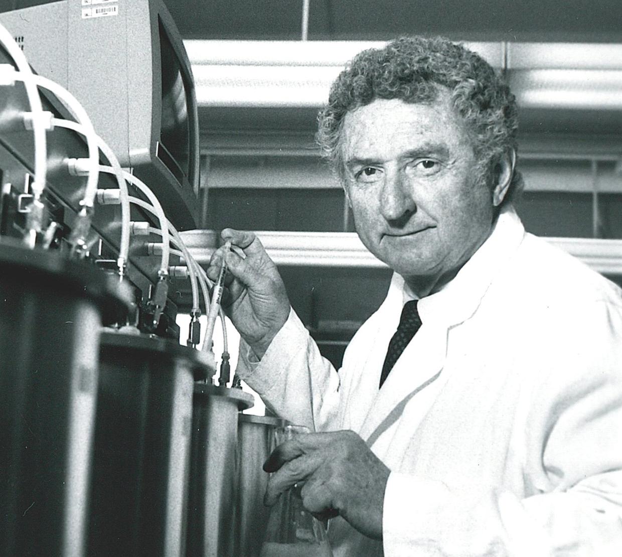 black and white photo of William Sandine working with lab equipment