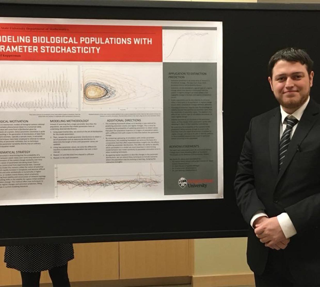 Michael Kupperman in front of his research poster