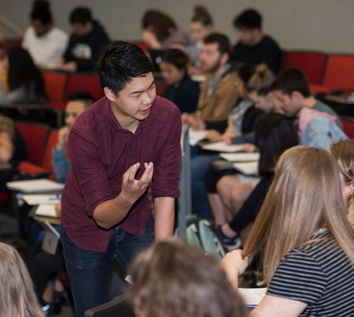 student learning assistant helping peers during lecture in the Learning Innovation Center