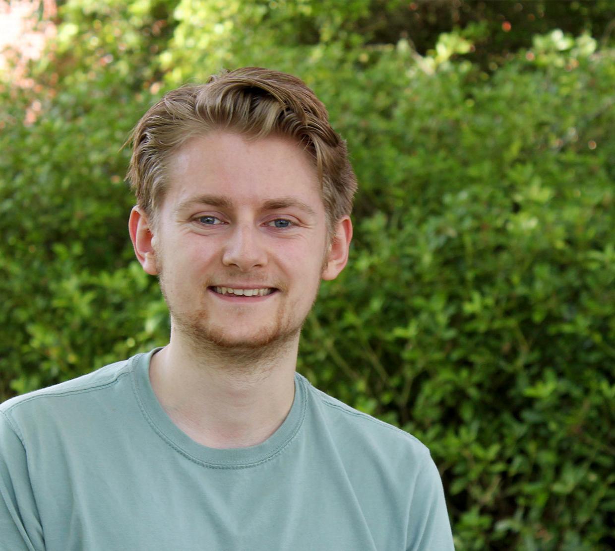 Ryan Tollefsen in front of Kidder Hall