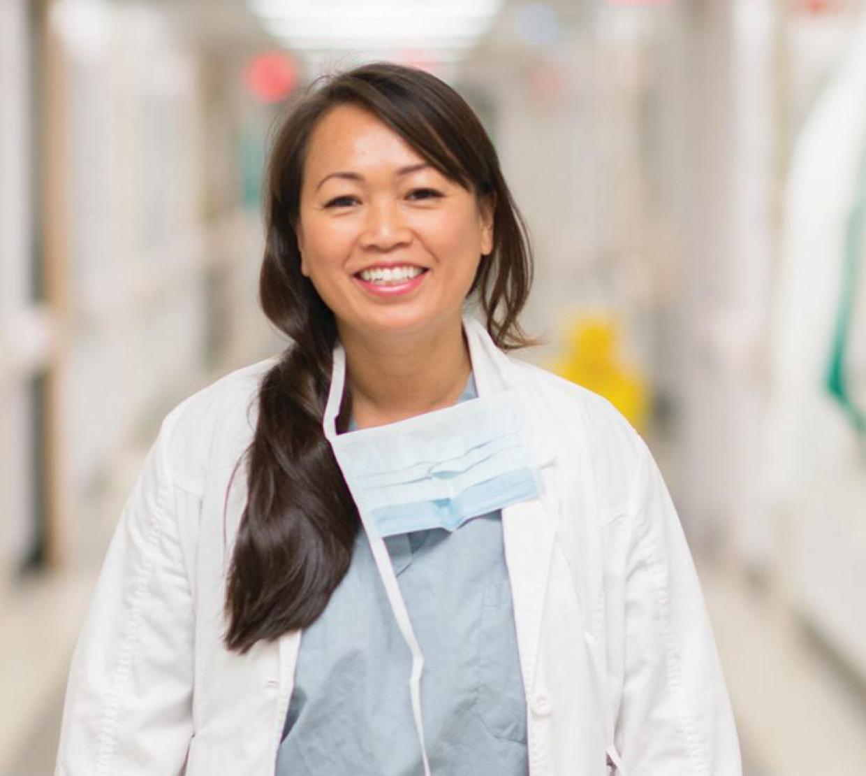 Dr. SreyRam Kuy wearing scrubs in hospital hallway