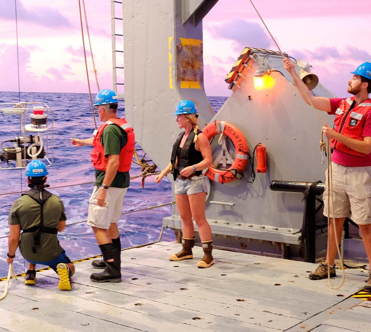 Researchers take a phytoplankton sample on an OSU research vessel.