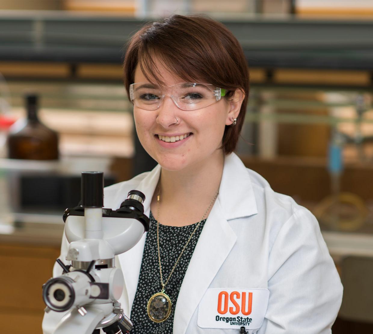 Grace Deitzler working with microscope in lab
