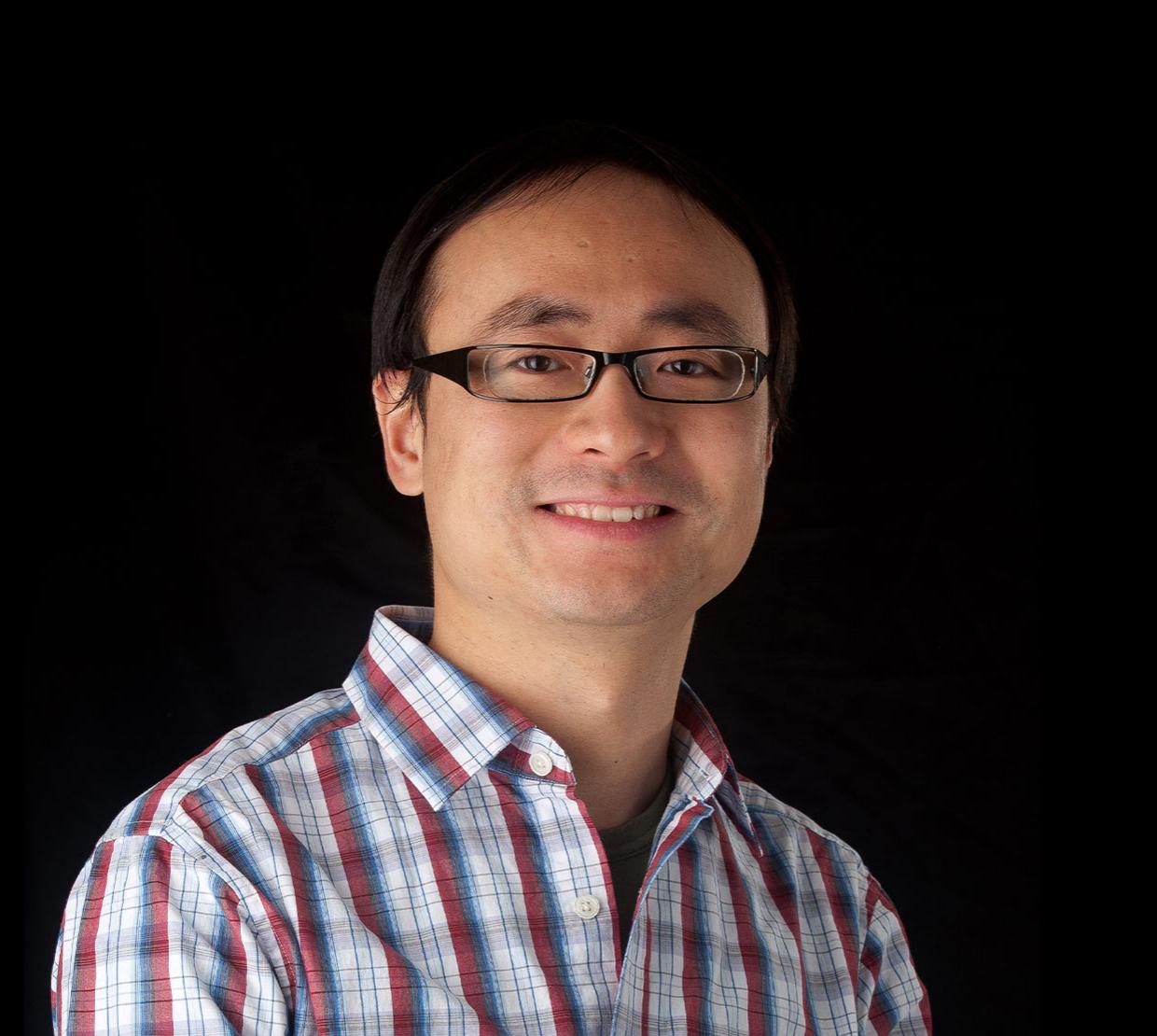 Chong Fang, standing in front of black backdrop