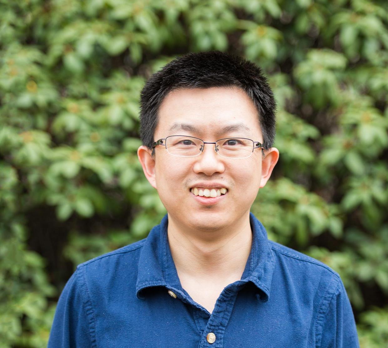 Bo Sun standing in front of shrubbery