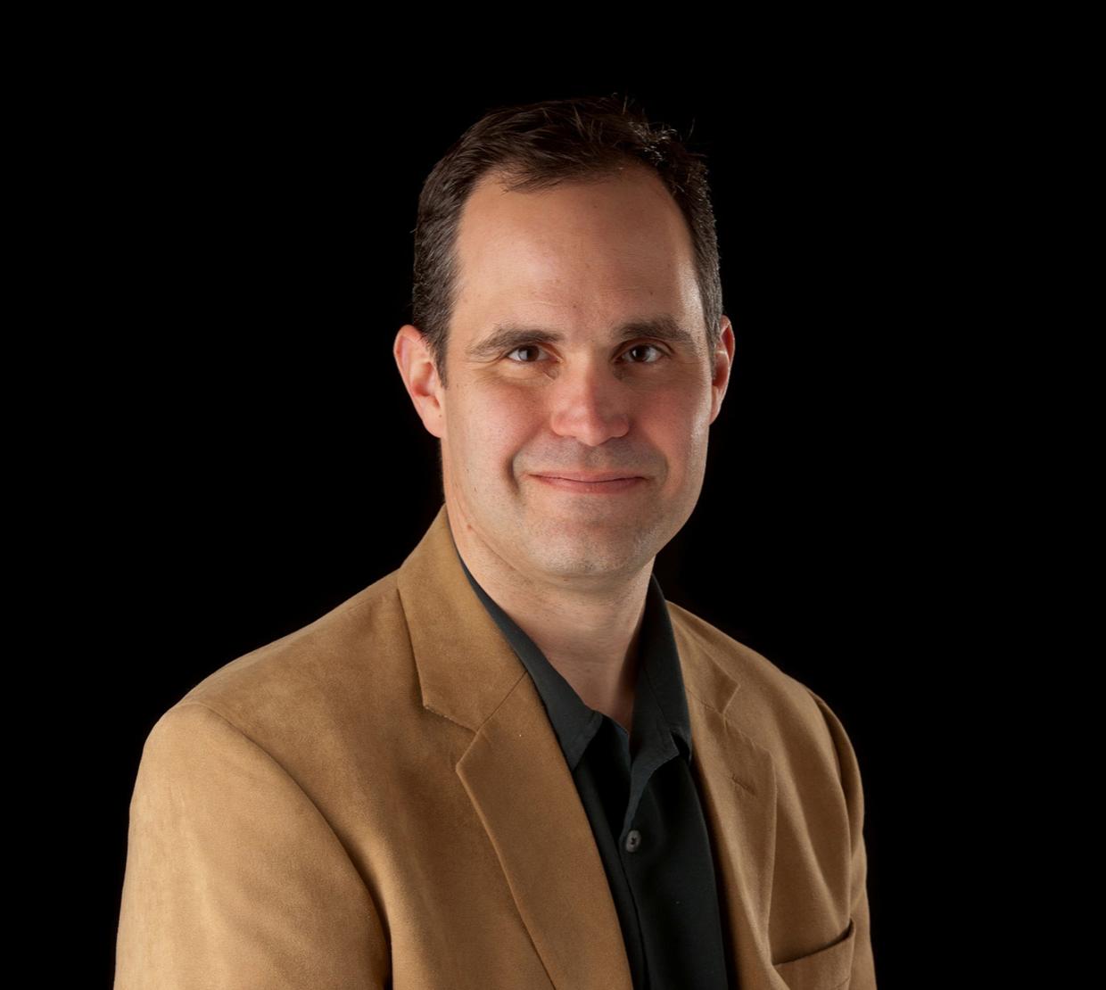 Rich Carter standing in front of black backdrop