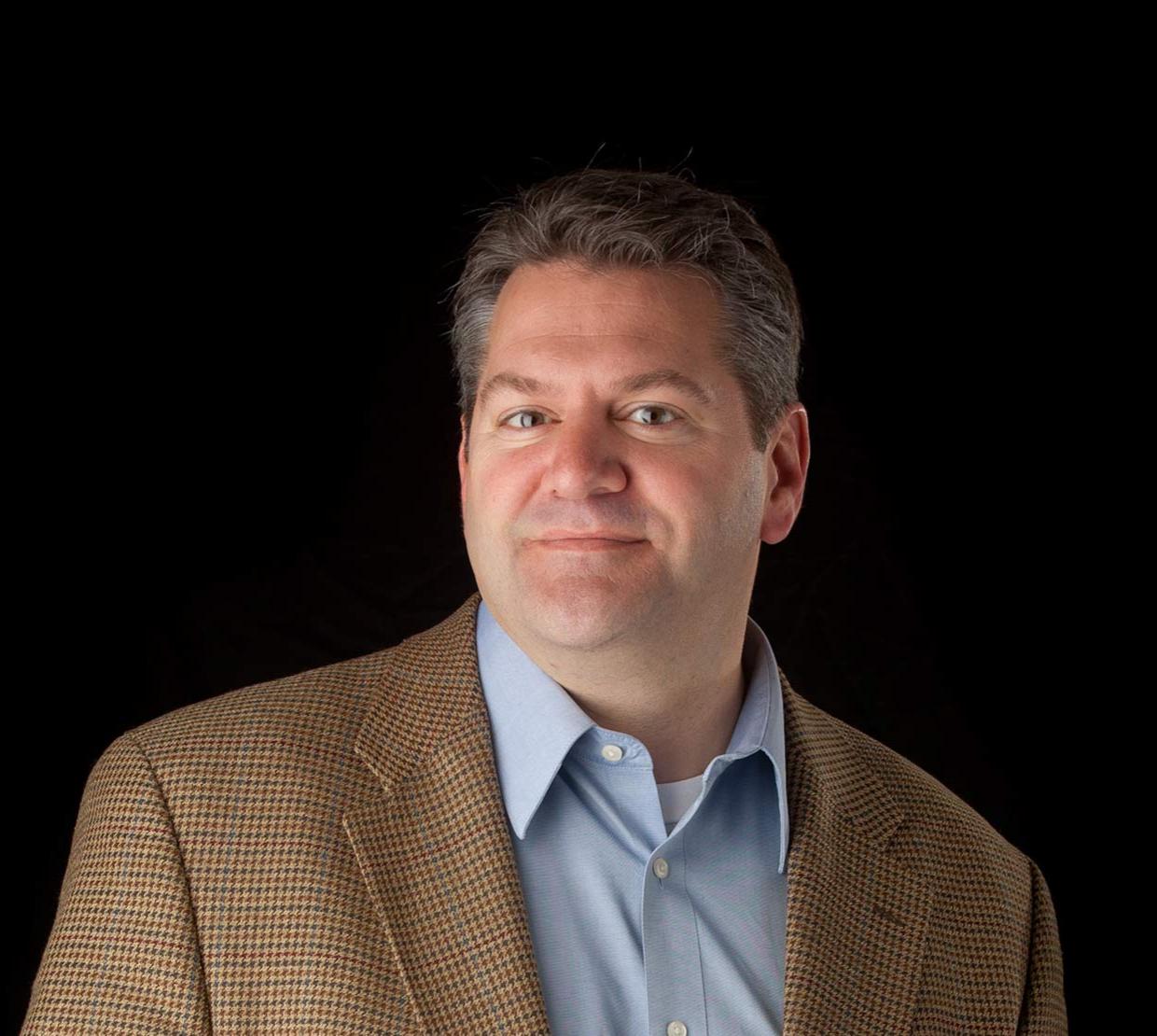 Vince Remcho standing in front of black backdrop