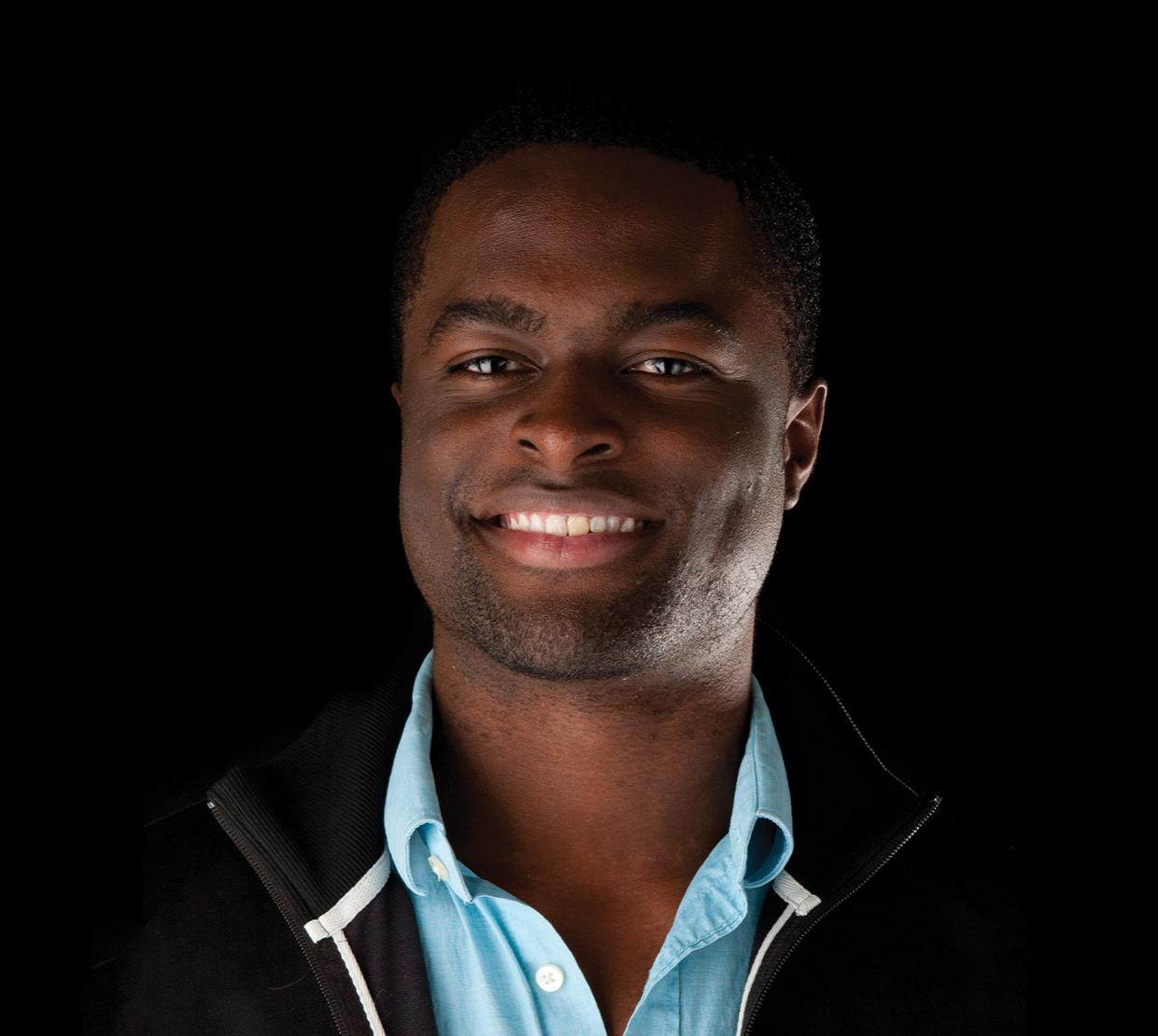 Maduka Ogba standing in front of black backdrop