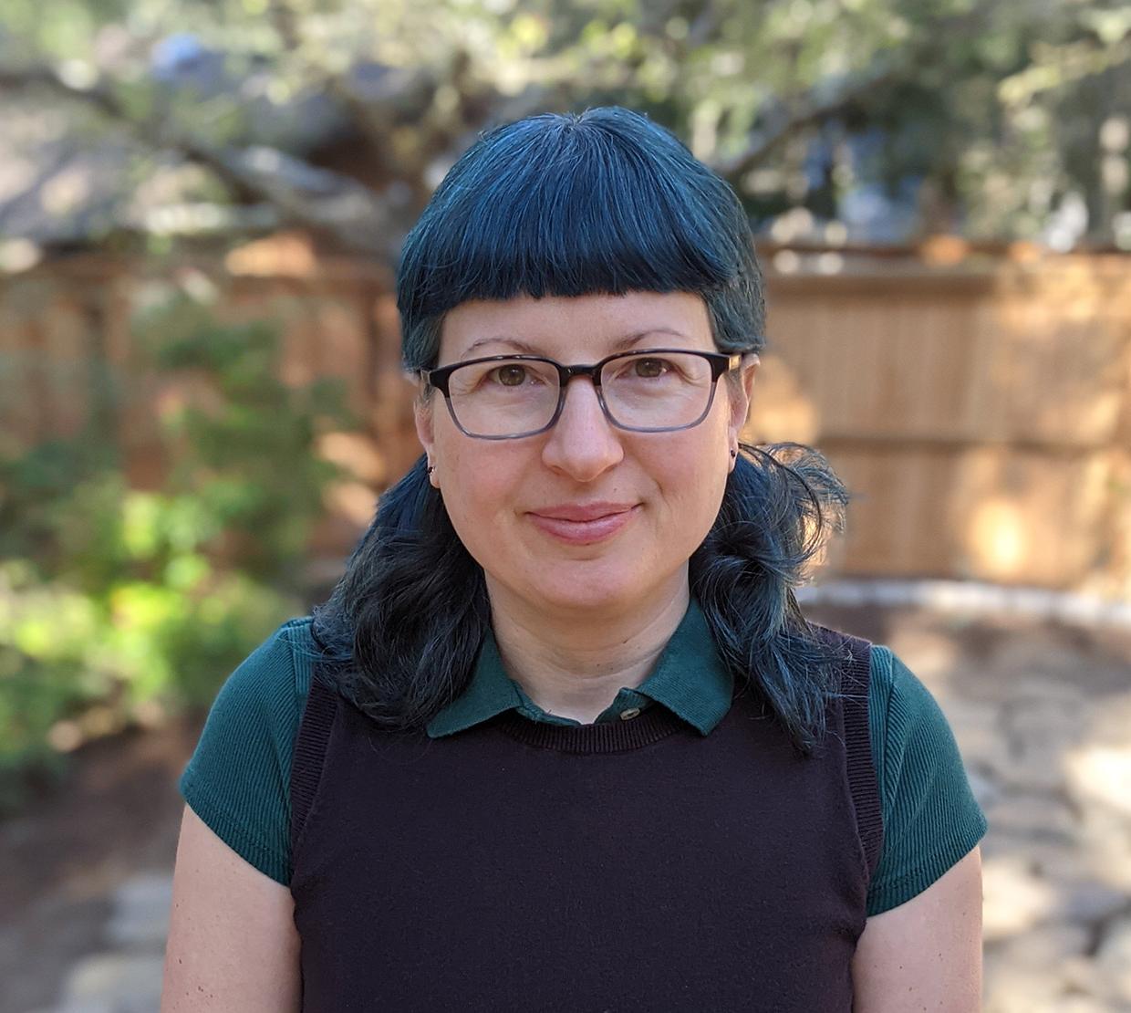 Holly Swisher standing in a backyard.