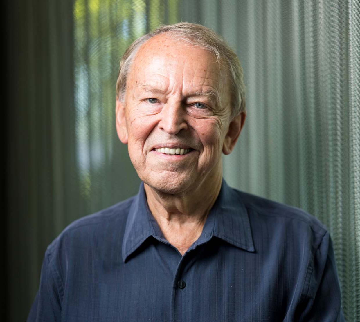 Ron Schoenheit standing in front of his innovative curtains