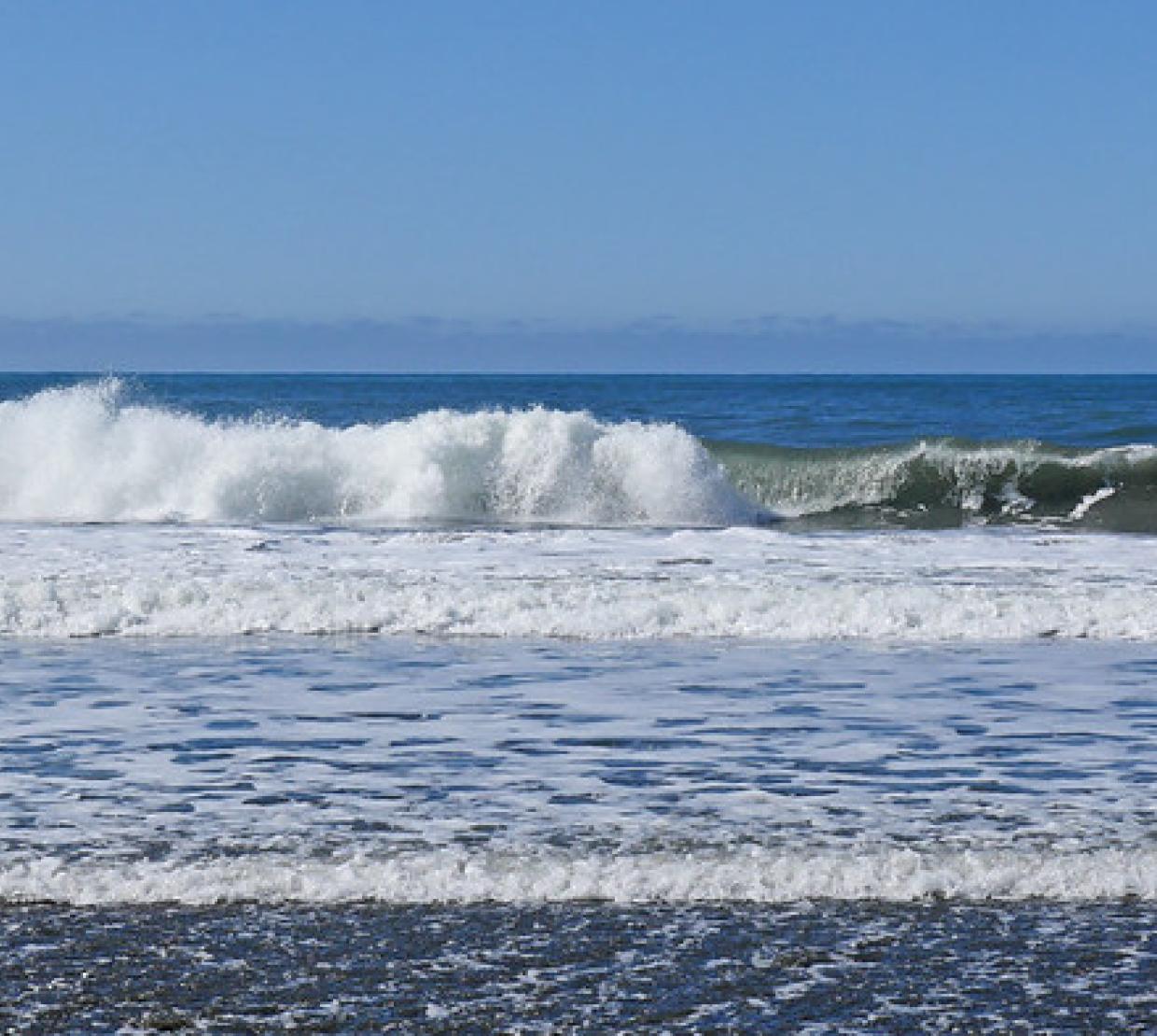 Waves crashing against the sand