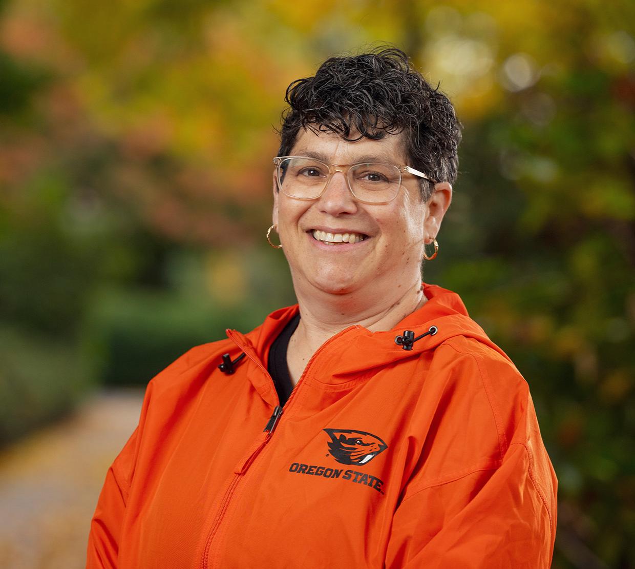 Dean Eleanor Feingold smiling in orange Oregon State jacket