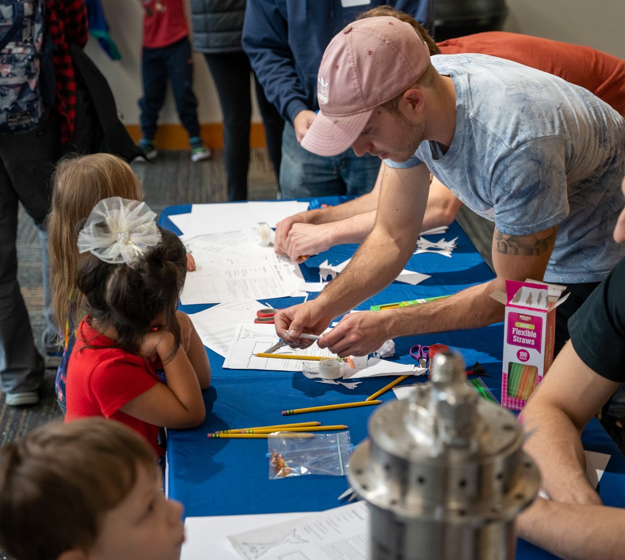 A male college student engages with children during Discovery Days