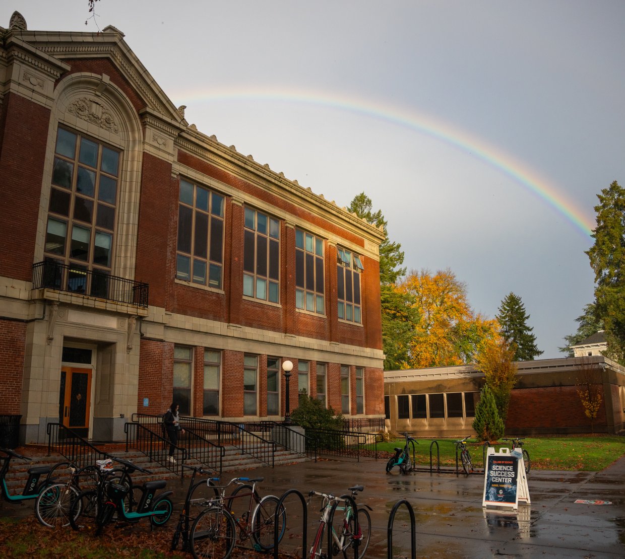 Kidder Hall with a rainbow in the background.
