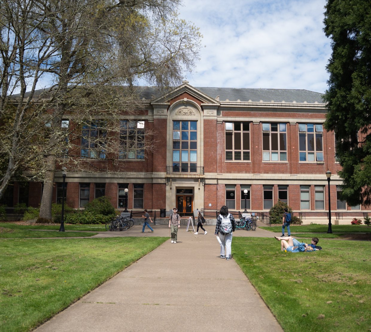 Photo of brick building, Kidder Hall, with students walking to class.