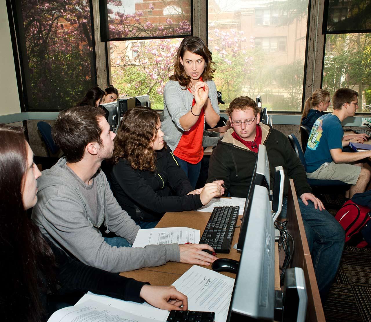 professor helping students in computer lab